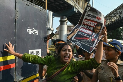 Police detain a supporter of the Cockroach Janata Party movement during a protest in Mumbai