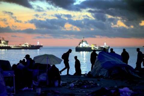 Scores of migrants drowned during July's chaotic surge in their attempt to swim around a border barrier