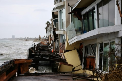 Dramatic photos and video footage showed homes along the city's peninsula teetering precariously, while its historic boardwalk was partially swept away