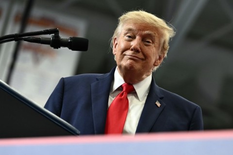 US President Donald Trump smiles as he finishes a speach in a hockey rink converted into a rally venue in Wasilla, Alaska
