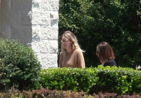 Theranos founder Elizabeth Holmes (L) arrives at a federal prison in Bryan, Texas, on May 30, 2023