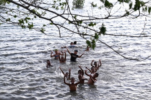 Children swim during high tide off Serua Island in Fiji