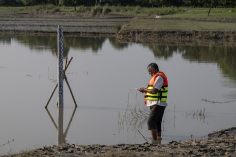 Bangladesh Water Development Board's gauge reader Nazir Uddin recording Padma river's water-level in Ujirpur, near the Bangladesh-India frontier in Bangladesh's Rajshahi division