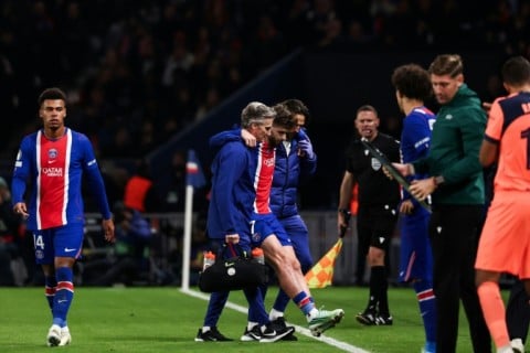 Khvicha Kvaratskhelia is helped off the pitch during PSG's game against Barcelona on Tuesday