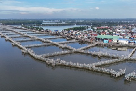 Bamboo sediment traps designed to slow water flow next to houses at Pamarawan Island in Malolos City, Bulacan province