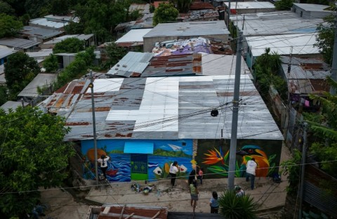 An aerial view shows the mural "Identity," painted by three Salvadoran female artists on the facade of a house in the 10 de Octubre community in San Marcos, El Salvador, on October 2, 2026. The artistic project aims to transform the identity of a community historically affected by gang violence.