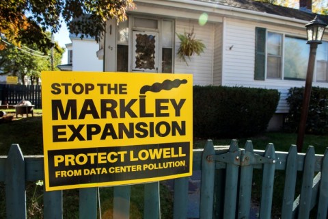 A sign expressing opposition to the expansion of the Markley Lowell Data Center is displayed outside a home in Lowell