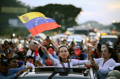 Venezuelan opposition leader and Nobel Peace Prize laureate Maria Corina Machado greets supporters in Caracas after almost a year in exile