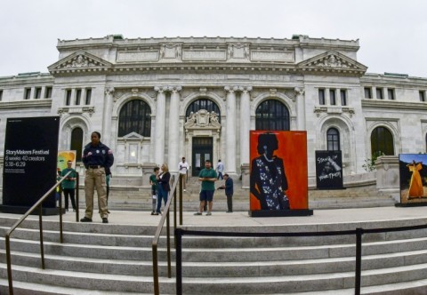 People stand around the historic Carnegie Library in downtown Washington, DC