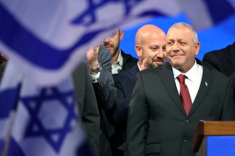 Yashar party leader Gadi Eisenkot (R) arrives to address his supporters at an election night rally after the first exit polls were announced, in Tel Aviv