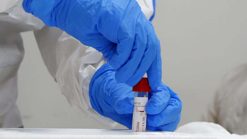 A paramedic seals a COVID-19 coronavirus disease screening test kit during a response training exercise.