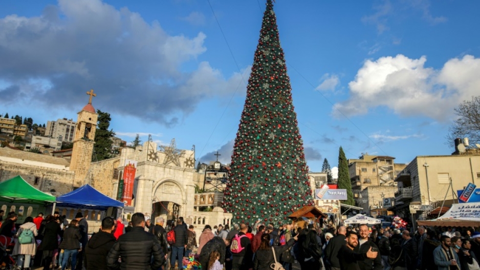 A crowd gathers around the giant Christmas tree outside the Greek Orthodox Church of the Annunciation, whose caretaker estimates Jewish Israelis have made up 90 percent of visitors this season