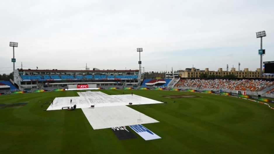 Groundsmen prepare to remove covers from the pitch in Rawalpindi after rain delayed the resumption of the Test match between Pakistan and Australia