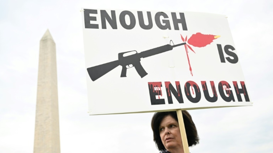 A gun control advocate holds a sign during a June 11, 2022 protest in Washington, DC that was organized by March for Our Lives