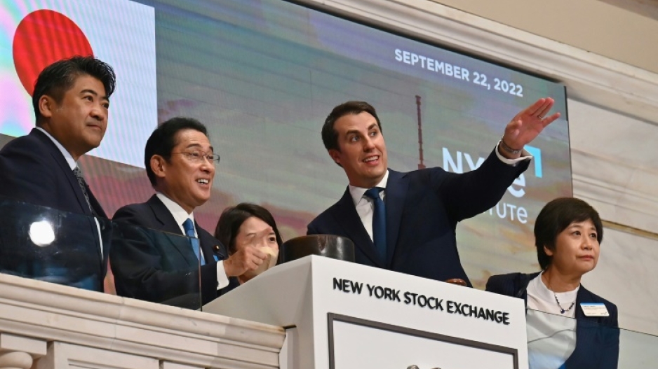 Japanese Prime Minister Fumio Kishida (2-L)  stands with John Tuttle (R), Vice Chairman of the NYSE Group, before ringing the closing bell at the New York Stock Exchange on September 22, 2022