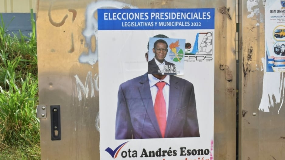 A campaign poster for Obiang is pasted over a poster of rival candidate Andres Esono Ondo of the Convergence for Social Democracy (CPDS), Equatorial Guinea's sole authorised opposition  party