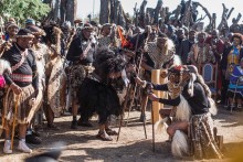 King of Amazulu nation Misuzulu kaZwelithini (C), traditional Prime Minister of the Zulu nation Prince Mangosuthu Buthelezi (R) hands over the Spear of Authority during the coronoation as the new King at the Amazulu nation at the KwaKhangelamankengane Royal Palace at Kwa-Nongoma some 300 kilometres north of Durban, on August 20, 2022.