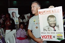 A supporter holds a poster of Inkatha Freedom Party leader Mangosuthu Buthelezi during the South Africa's first multi-racial elections in Umlazi, a black township, south of Durban on April 27, 1994.