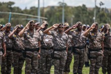 Members of South African Presidential Protection Service salute during the Integrated Law Enforcement parade near the Nasrec Expo Centre in Johannesburg, on November 19, 2025.