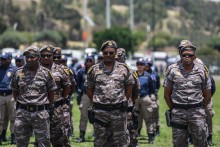 Members of South African Presidential Protection Service stand at attention during the Integrated Law Enforcement parade near the Nasrec Expo Centre in Johannesburg, on November 19, 2025.