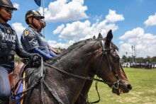 Members of the South African Police Service (SAPS) Mounted Unit join a march during the Integrated Law Enforcement parade near the Nasrec Expo Centre in Johannesburg, on November 19, 2025.