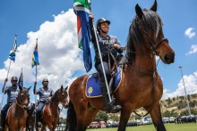 Members of the South African Police Service (SAPS) Mounted Unit join a march during the Integrated Law Enforcement parade near the Nasrec Expo Centre in Johannesburg, on November 19, 2025.