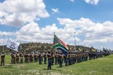 Members of the South African Police Service (SAPS) stand at attention during the Integrated Law Enforcement parade near the Nasrec Expo Centre in Johannesburg, on November 19, 2025.