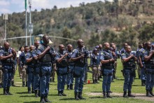 Members of the South African Police Service (SAPS) stand at attention during the Integrated Law Enforcement parade near the Nasrec Expo Centre in Johannesburg, on November 19, 2025.