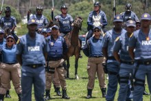 Members of the South African Police Service (SAPS) Mounted Unit stand at attention during the Integrated Law Enforcement parade near the Nasrec Expo Centre in Johannesburg, on November 19, 2025.