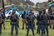 Members of the South African Police Service (SAPS) stand at attention during the Integrated Law Enforcement parade near the Nasrec Expo Centre in Johannesburg, on November 19, 2025.