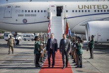 Britain's Prime Minister Keir Starmer (C-L) is welcomed by a South African representative upon his arrival at OR Tambo International Airport in Ekurhuleni on November 21, 2025 ahead of the G20 leaders' Summit.