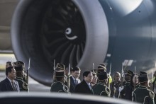 Vietnam Prime Minister Pham Minh Chinh (C) walks through a South African National Defense Forces (SANDF) honor guard upon his arrival at the OR Tambo International airport in Ekurhuleni on November 21, 2025 ahead of the G20 leader's Summit.