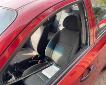 A red Chevrolet Aveo sedan, with a shattered window belonging to Brown Mogotsi