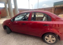 A red Chevrolet Aveo sedan belonging to Brown Mogotsi
