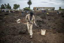 A man digs using a spade in a patch of land where artisanal miners look for gold outside Springs, Ekurhuleni, on February 15, 2026.