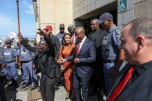 Economic Freedom Fighters (EFF) leader Julius Malema (CR) and his wife Mantwa Malema (CL) leave the KuGompo City Regional court in East London on April 15, 2026 following his sentencing for firing an assault rifle at a rally eight years ago.