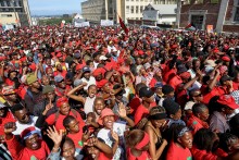 Supporters of Economic Freedom Fighters (EFF) leader Julius Malema listen to his speech outside the KuGompo City Regional court in East London on April 15, 2026 following his sentencing for firing an assault rifle at a rally eight years ago.