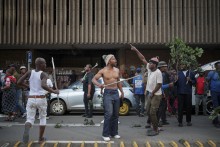 Protestors gesture in the street during a protest march against undocumented migrants organised by “March and March” in Johannesburg on April 29, 2026.