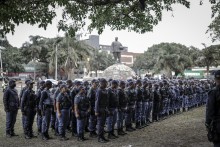 Members of the South African Police Service (SAPS) stand in formation as they receive instructions ahead of planned demonstrations by the March and March movement. AFP/Marco Longari