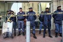 Members of the South African Police Service (SAPS) stand in formation as they monitor a demonstration by the &amp;quot;March and March&amp;quot; and Operation Dudula movements.  AFP/Rodger Bosch
