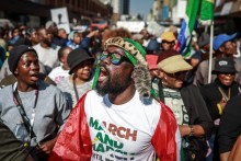 Protesters chant slogans as they march during a demonstration by the &amp;quot;March and March&amp;quot; and Operation Dudula movements. AFP/Phill Magakoe