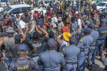 Protestors from the anti-illegal immigration group, March and March Movement chant slogans outside the Department of Home Affairs Refugee Reception Centre during a demonstration at the Che Guevara Road in Durban, on October 8, 2026.