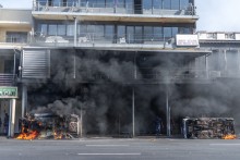 Cars are set alight after clashes erupt between protesters and foreign nationals in Durban on October 8, 2026.