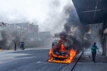 Police officers intervene as clashes erupt between protesters and foreign nationals in Durban. AFP/Rajesh Jantilal