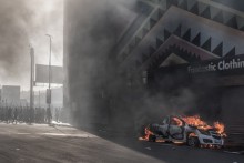 A car is set alight after clashes erupted between protesters and foreign nationals in Durban on October 8, 2026