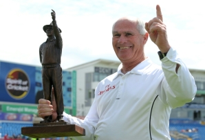 South African Rudi Koertzen holds a statue of himself while umpiring his final Test, between Australia and Pakistan in England during 2010. 
