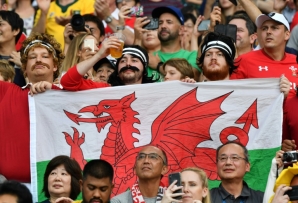 Supporters hold a Wales flag at the 2019 Rugby World Cup