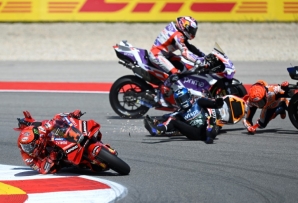 Francesco Bagnaia (left) avoids the crash that wiped out Marc Marquez (right) and Miguel Oliveira