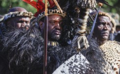 File: King of Amazulu nation Misuzulu kaZwelithini (C) gestures as he stands with Amabutho (Zulu regiments) during his coronation at the KwaKhangelamankengane Royal Palace in Kwa-Nongoma 300km north of Durban on August 20, 2022. Phill Magakoe / AFP