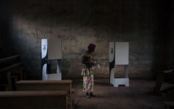 A voter prepares to vote at the Barthélemy Boganda high school polling station in the 1st district in Bangui, Central African Republic (CAR), on December 27, 2020 during the country's presidential and legislative elections. 